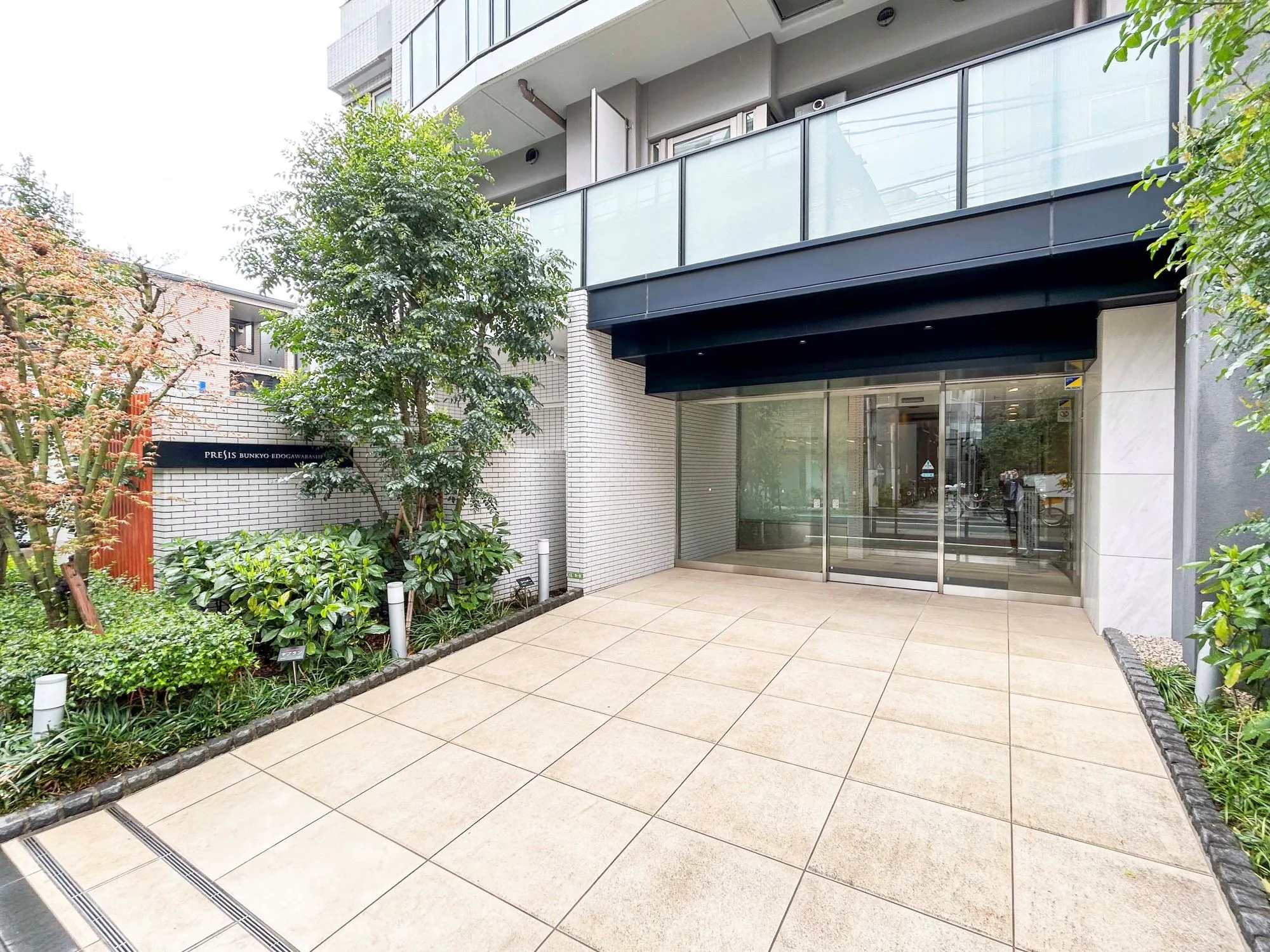 建物の外観全体を捉えた写真で、入口や周辺の緑地が含まれている