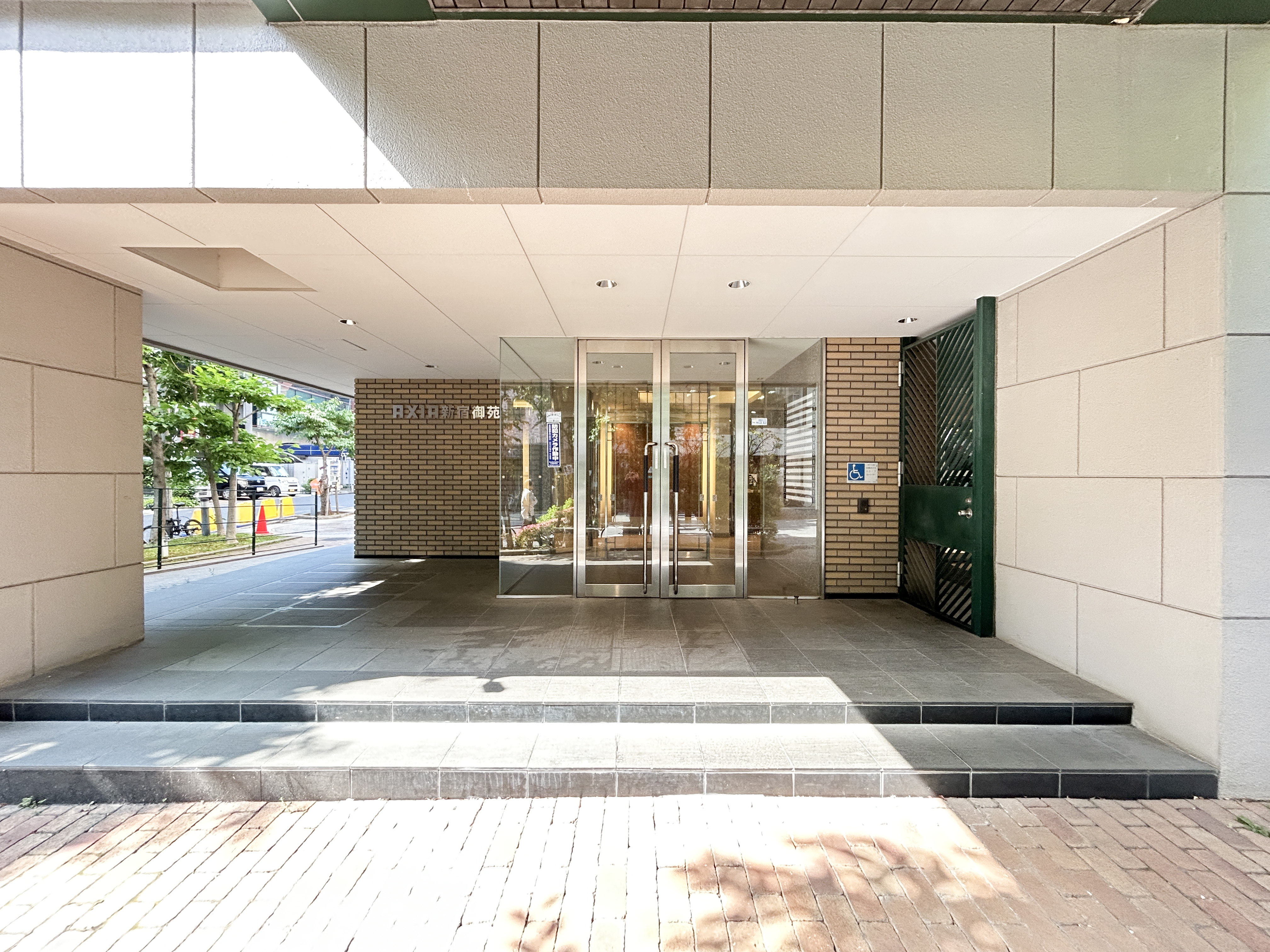 建物の玄関部分（ガラス扉、庇付きエントランス）が主体の写真